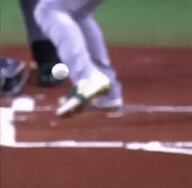 A GIF of a professional baseball game. The ball hits the batter's butt and causes it to jiggle hypnotically
